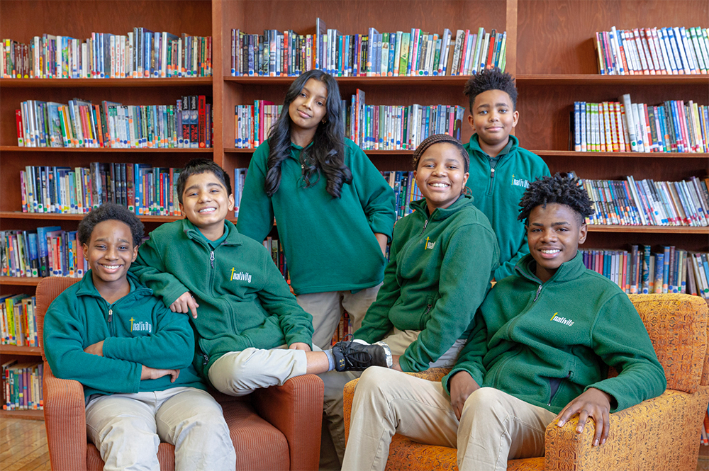 Nativity Preparatory Academy students in a library setting.