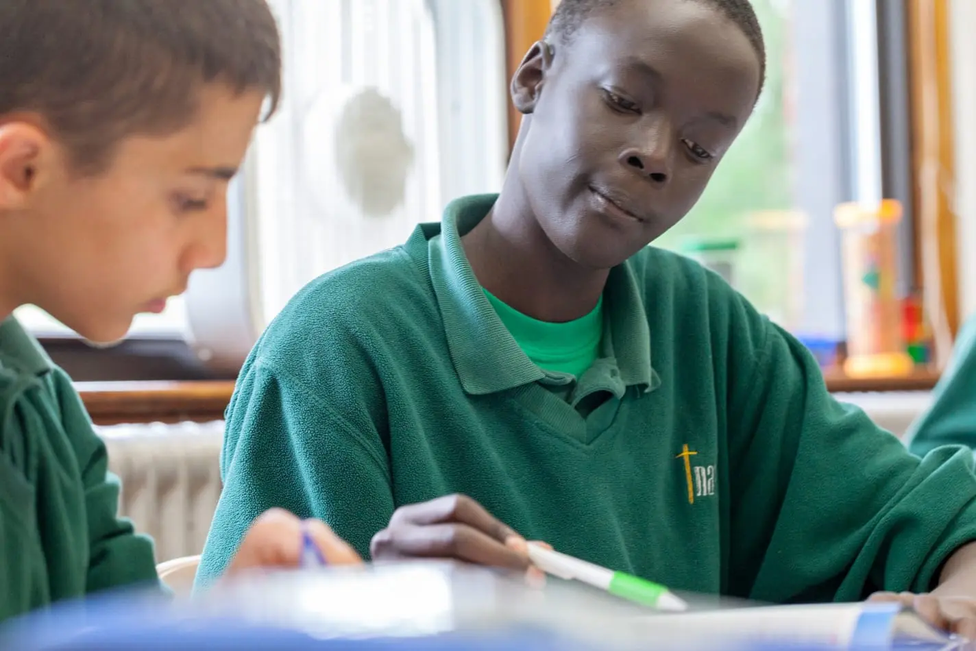 Two Nativity Prep students working together at their desks