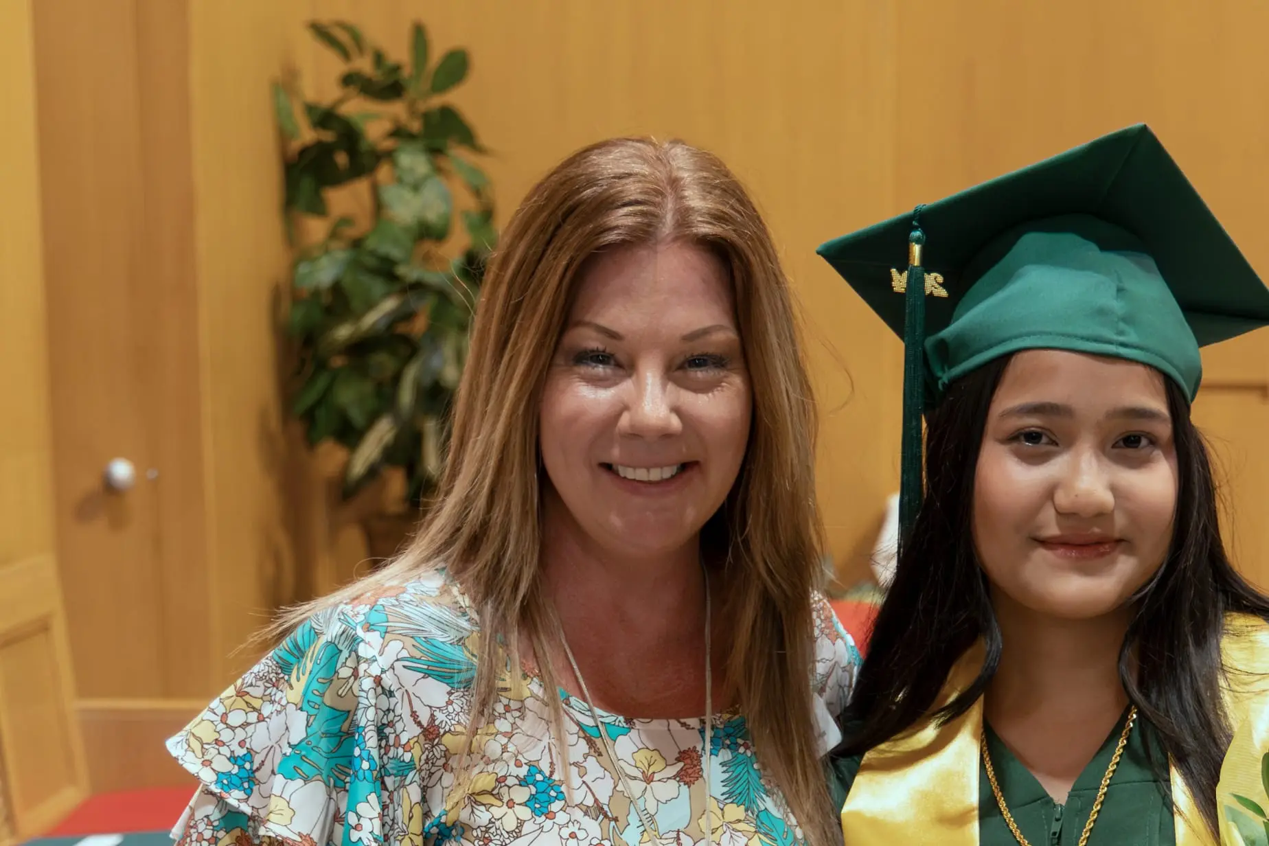 Jennifer Kremer and a Nativity Prep graduate at a commencement ceremony