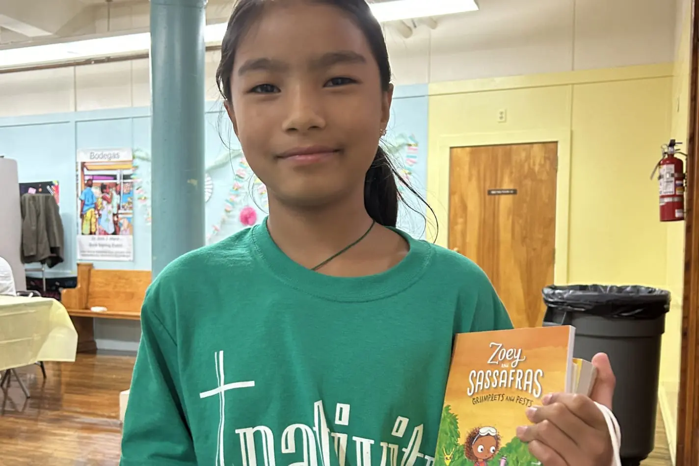 A Nativity Preparatory Academy student displaying a book